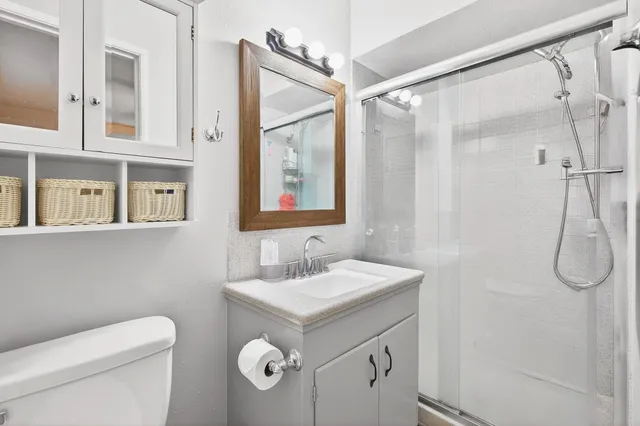 a bathroom with a toilet sink and mirror