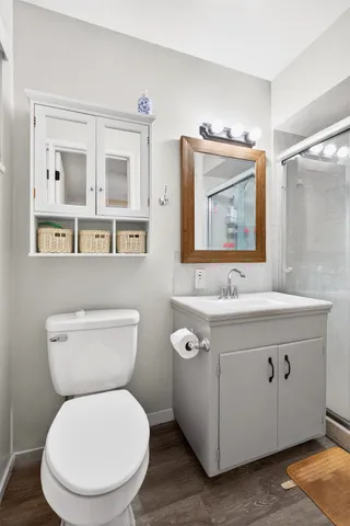 a bathroom with a granite countertop sink mirror and shower