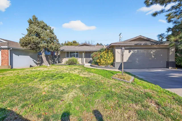 a front view of a house with a yard and garage