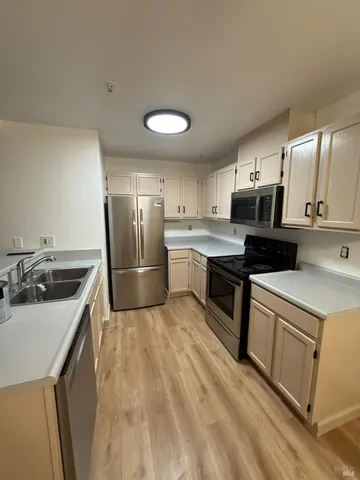 a kitchen with a sink appliances and cabinets