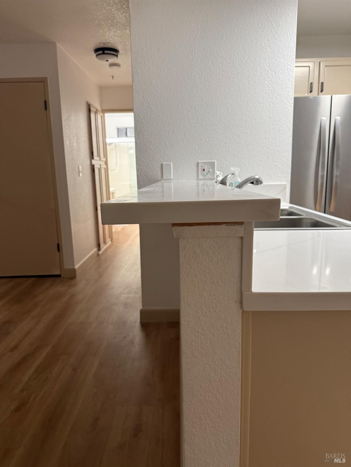 136 Sea Crest Circle Vallejo, CA 94590 - Photo 23 of 29 a kitchen with stainless steel appliances a refrigerator and wooden floor