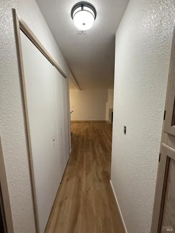 a view of a hallway and wooden floor