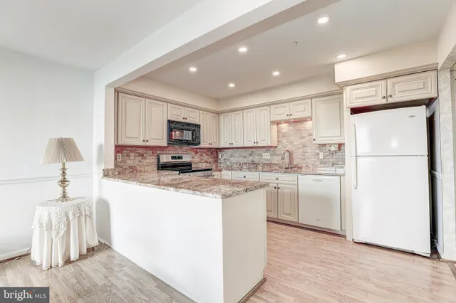 a large white kitchen with a large window