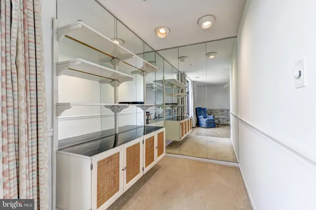 a spacious bedroom with a bed and large windows