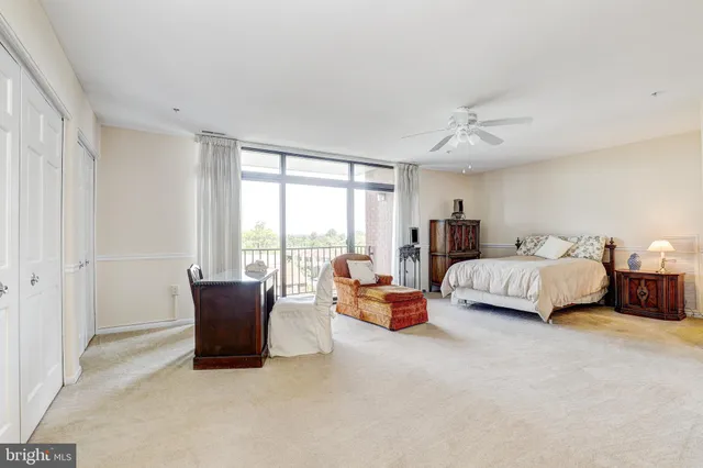 a bedroom with a large bed and a couch