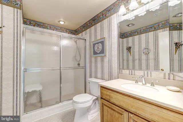 a spacious bathroom with a double vanity sink toilet and shower