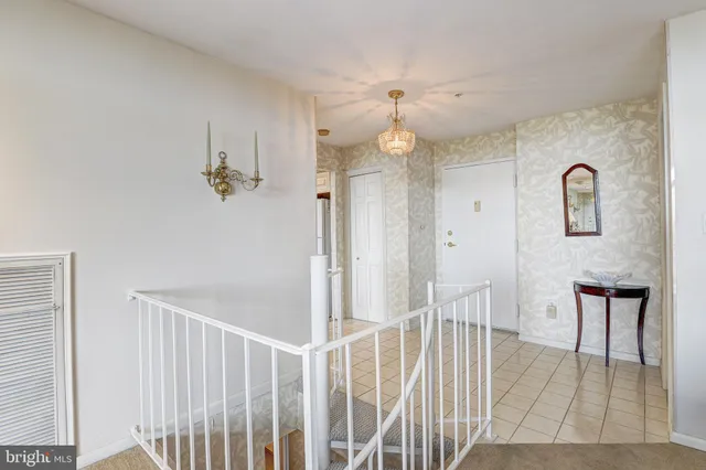 a view of a hallway with entryway wooden floor and front door
