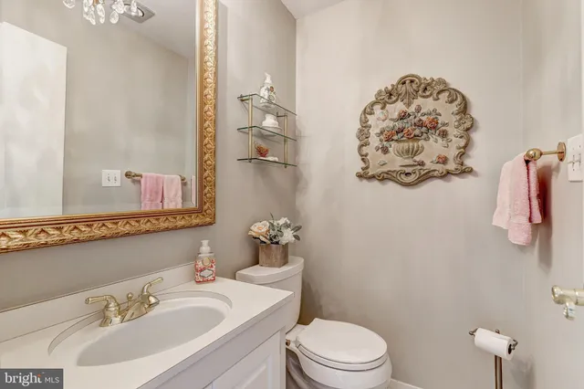a bathroom with a sink mirror vanity and toilet
