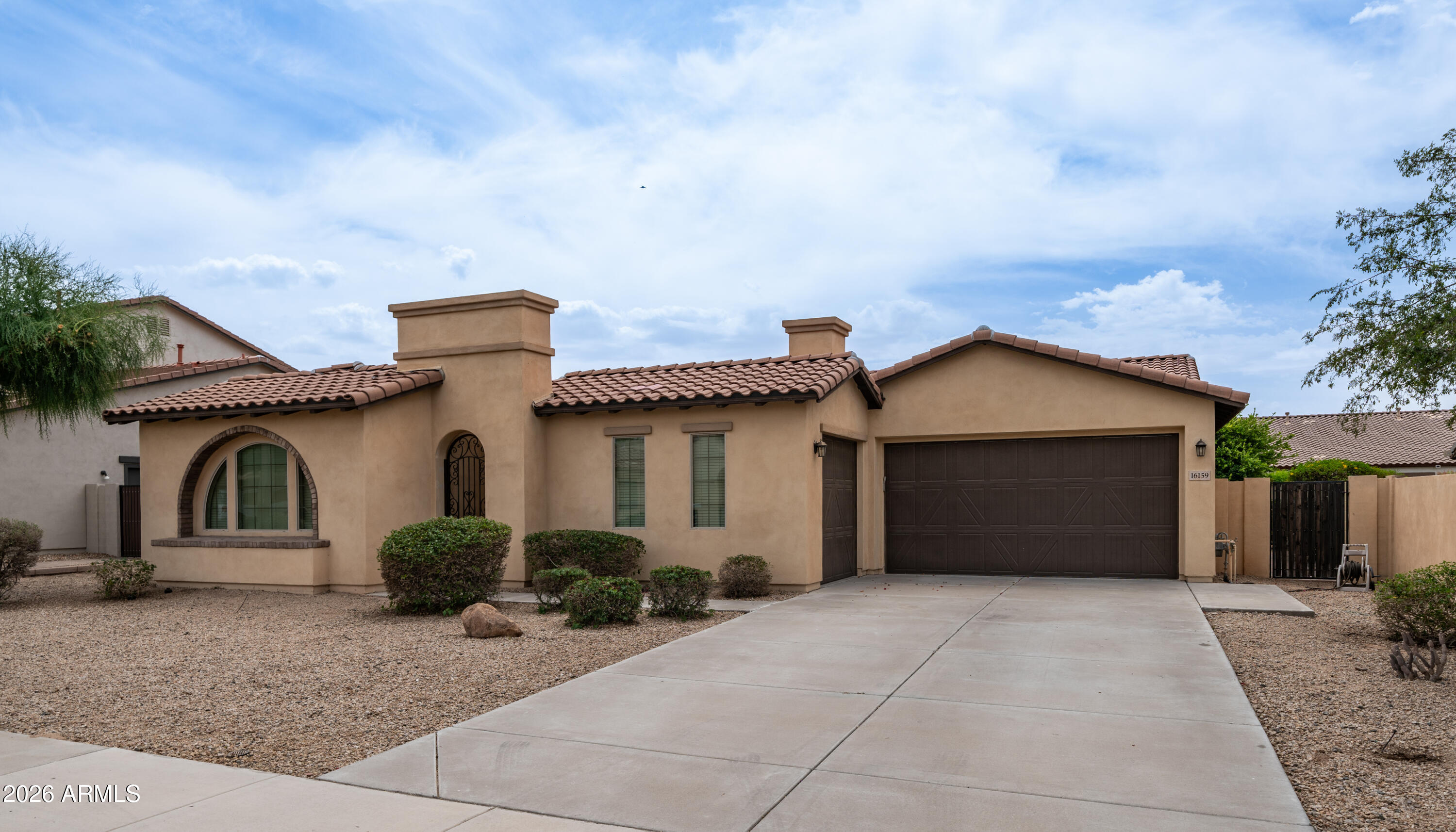 16159 West Granada Road Goodyear, AZ 85395 - Photo 40 of 41 a front view of a house with a yard and garage