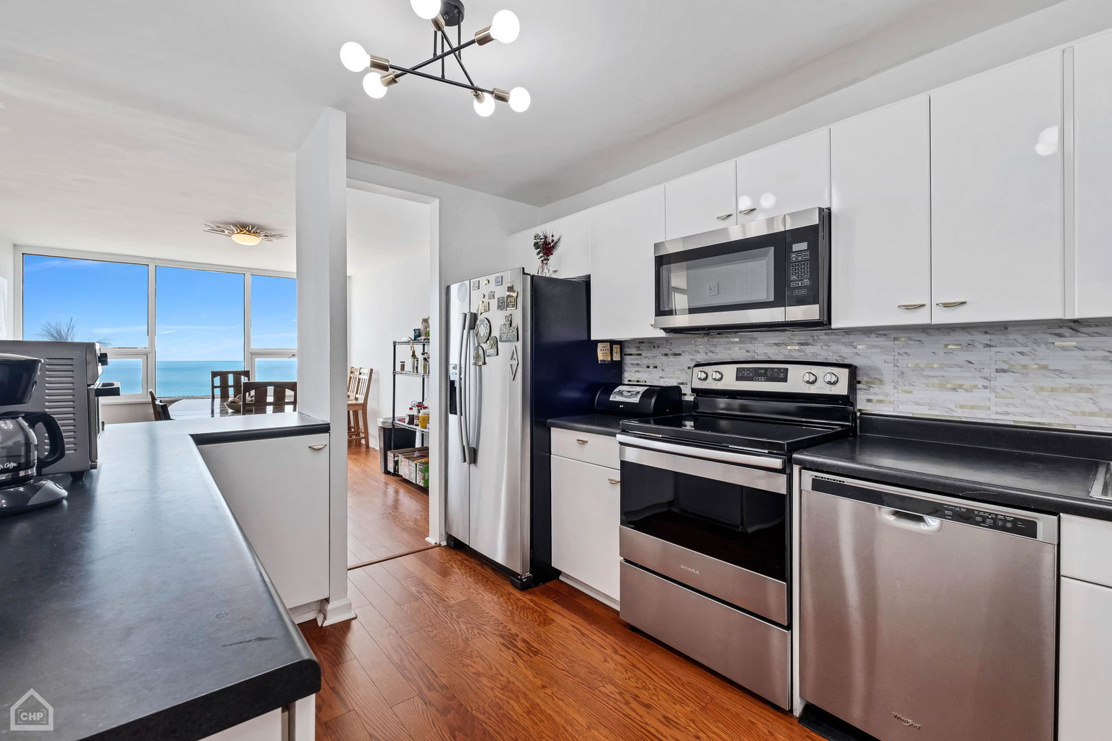 5733 North Sheridan Road, Unit 25C Chicago, IL 60660 - Photo 11 of 39 a kitchen with stainless steel appliances a stove microwave and a refrigerator