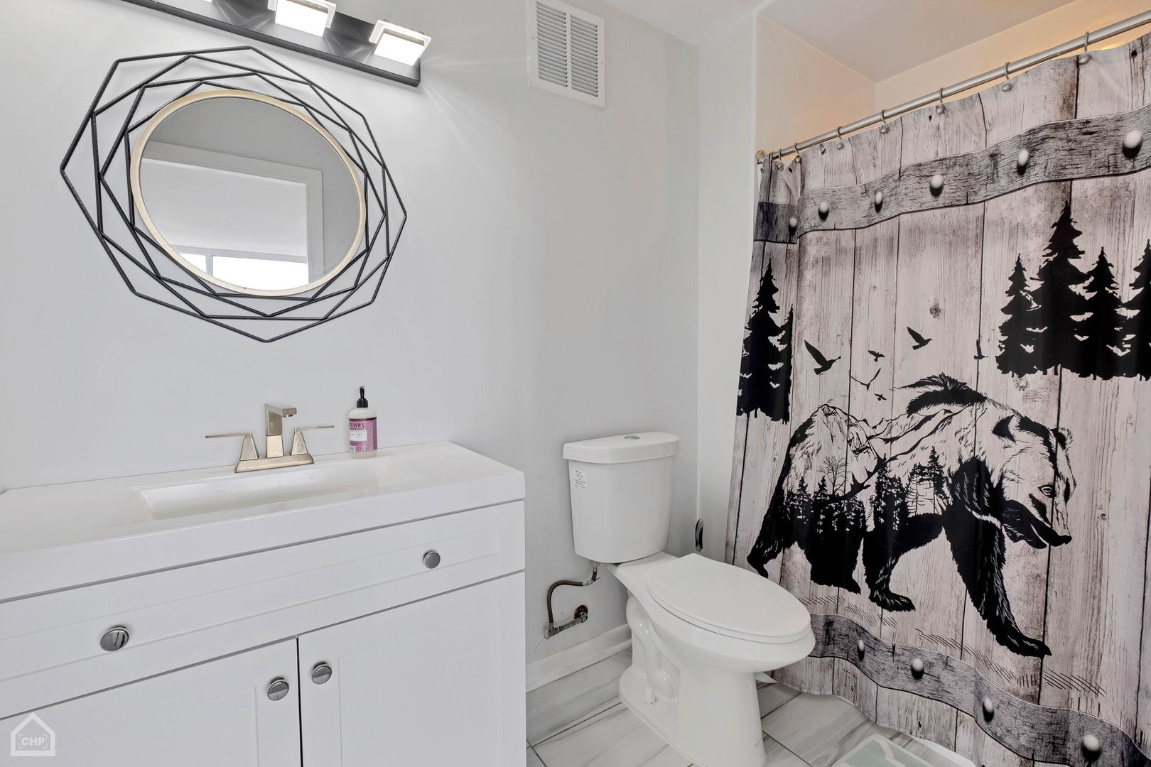 5733 North Sheridan Road, Unit 25C Chicago, IL 60660 - Photo 16 of 39 a bathroom with a sink a toilet and a mirror