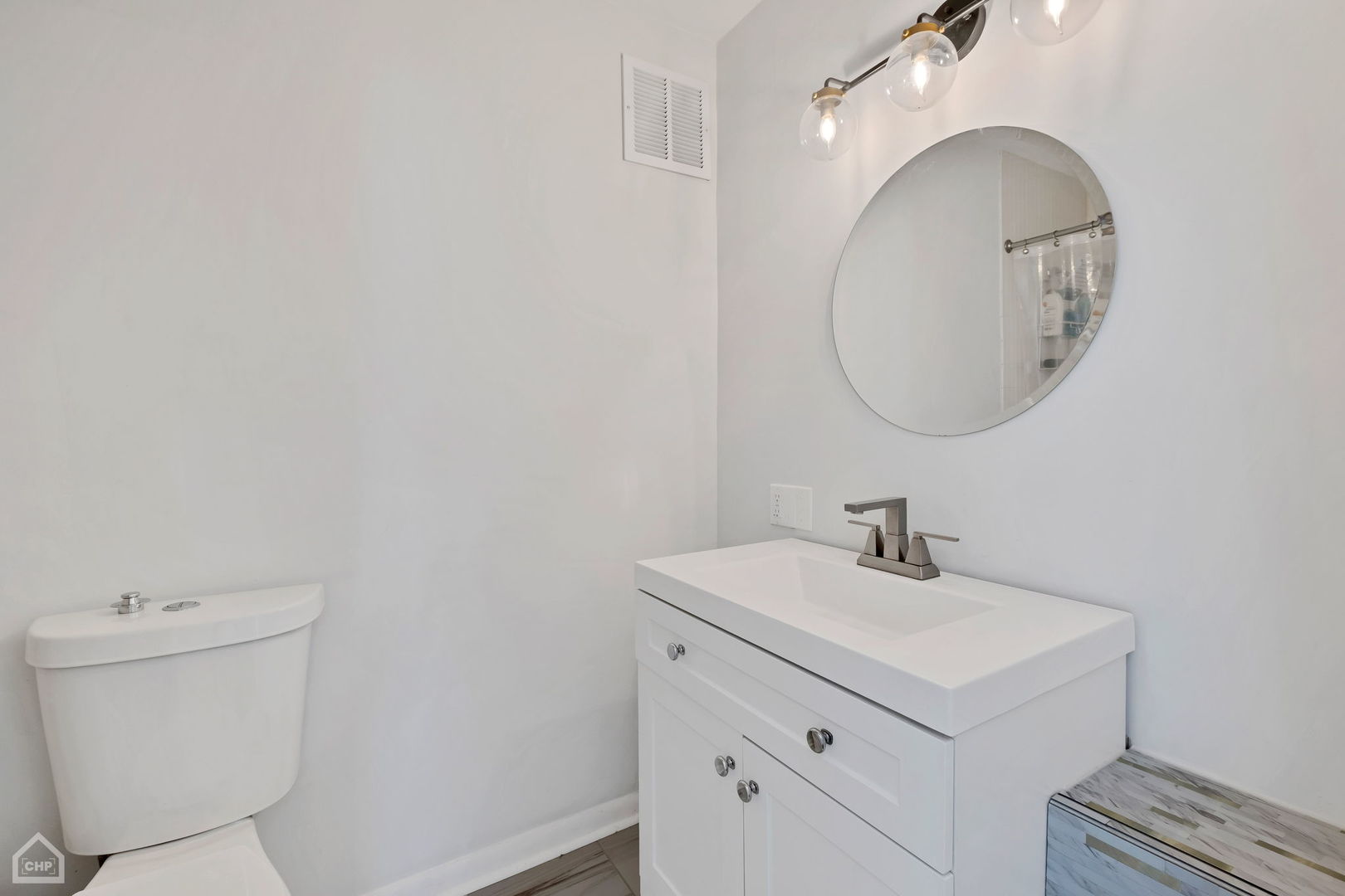 5733 North Sheridan Road, Unit 25C Chicago, IL 60660 - Photo 17 of 39 a bathroom with a sink a toilet and a mirror