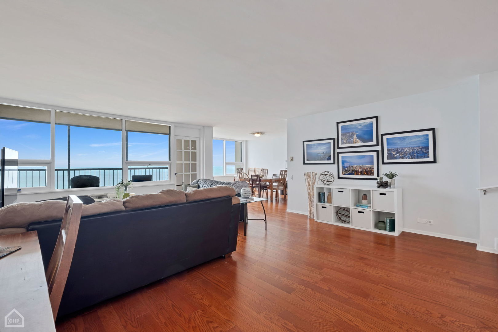 5733 North Sheridan Road, Unit 25C Chicago, IL 60660 - Photo 4 of 39 a living room with furniture a wooden floor and a window