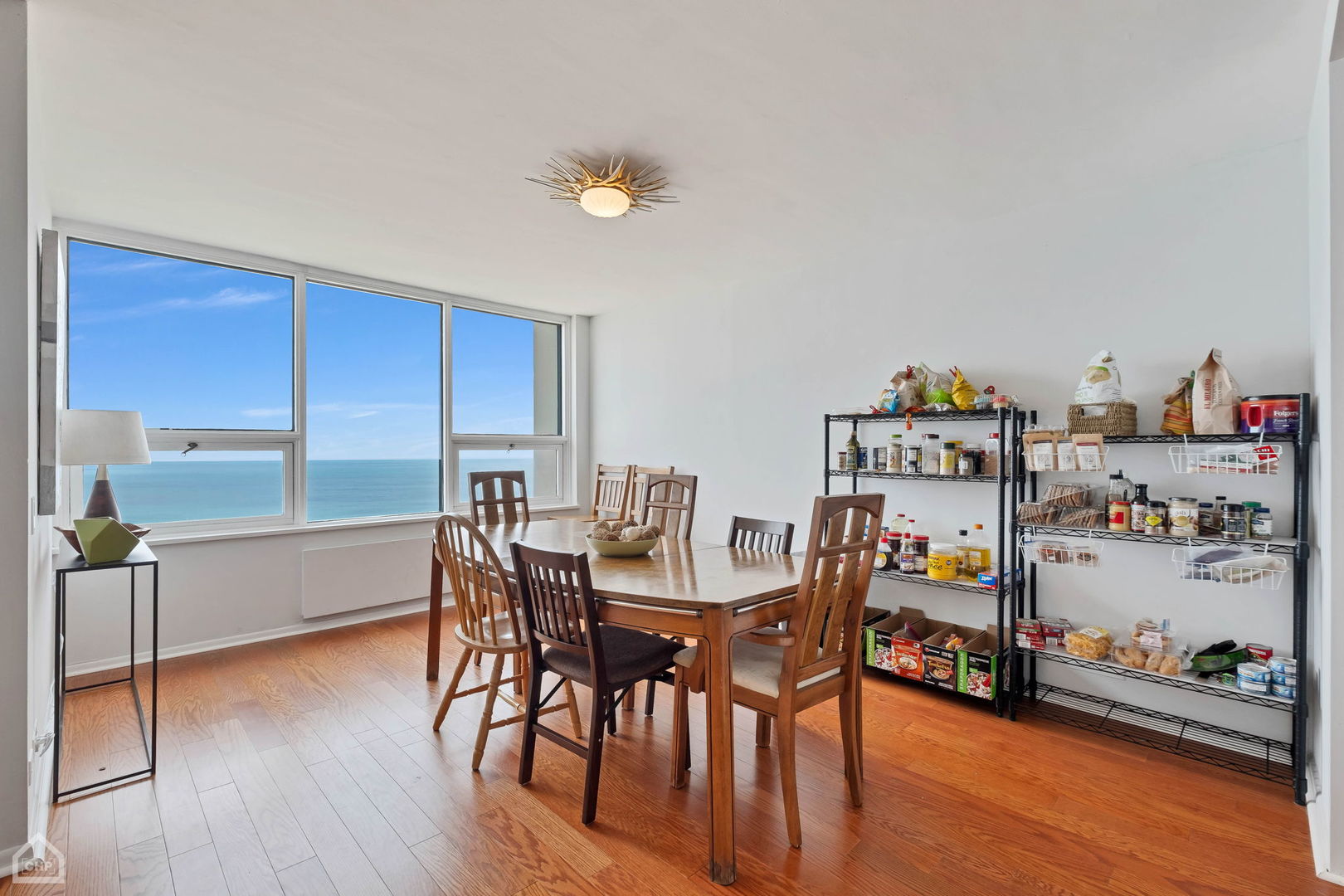 5733 North Sheridan Road, Unit 25C Chicago, IL 60660 - Photo 5 of 39 a view of a dining room with furniture and wooden floor
