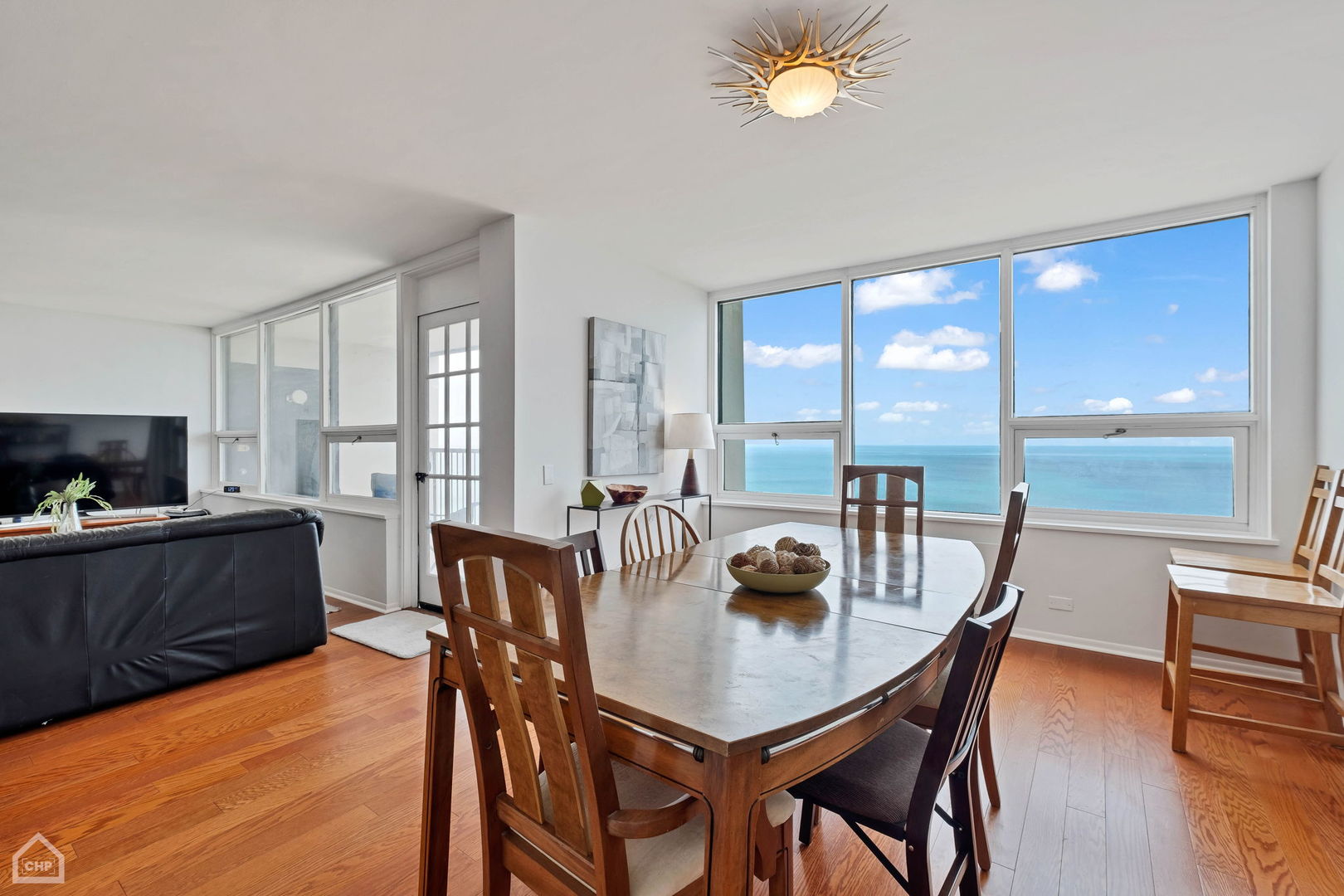 5733 North Sheridan Road, Unit 25C Chicago, IL 60660 - Photo 6 of 39 a view of a dining room with furniture window and wooden floor