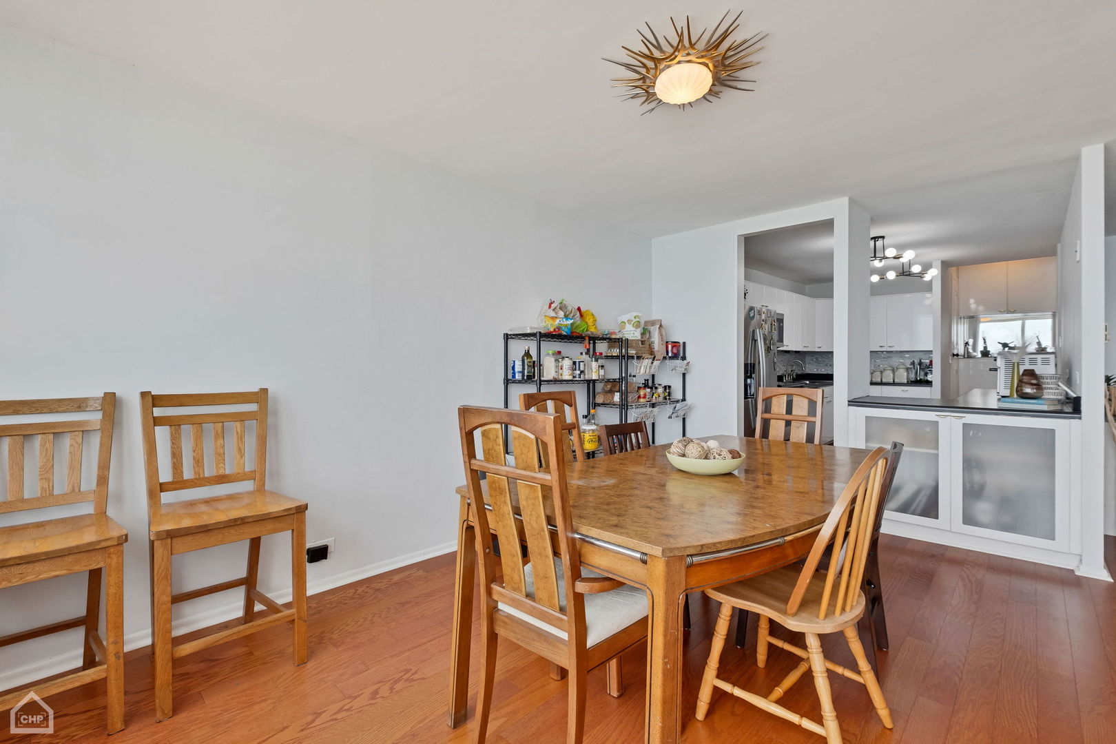 5733 North Sheridan Road, Unit 25C Chicago, IL 60660 - Photo 10 of 39 a view of a dining room with furniture and wooden floor