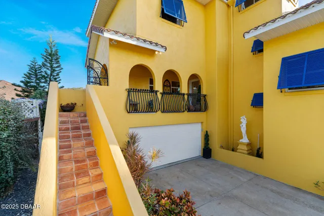 a front view of a house with a yard table and chairs