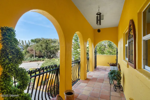 a living room with furniture a chandelier and a window