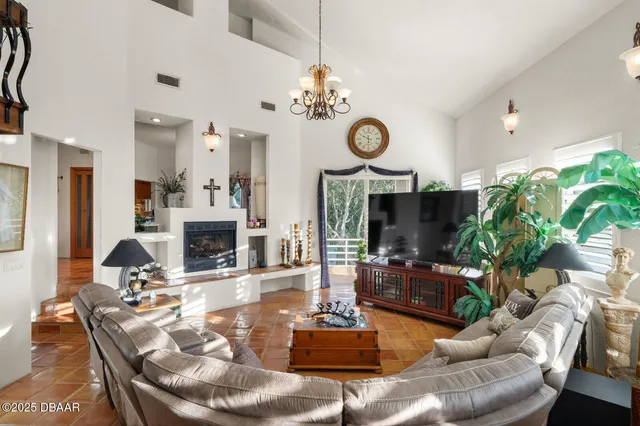 a view of a hallway with wooden floor and a living room