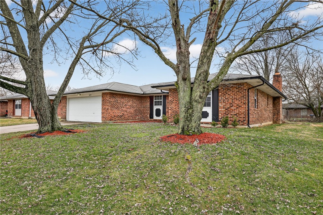 6070 Charlesgate Road Huber Heights, OH 45424 - Photo 2 of 29 This classic brick residence features a functional layout and a welcoming facade, framed by mature trees.