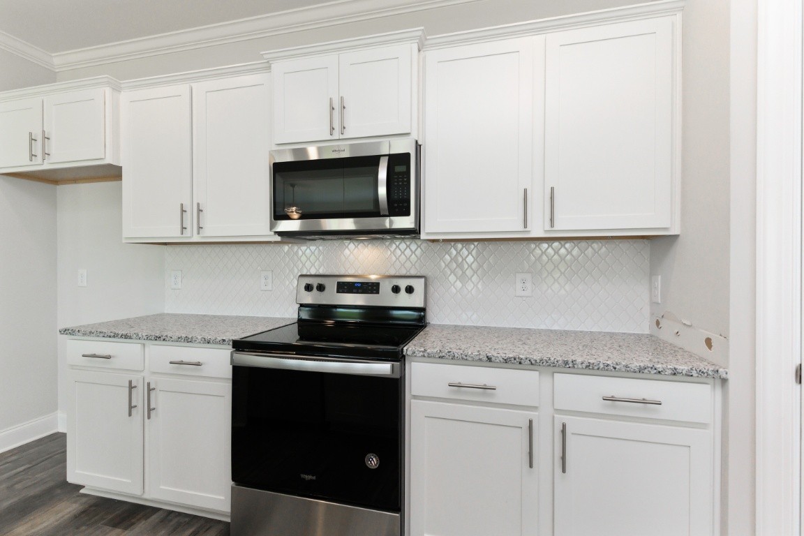 404 Butler Road Mount Juliet, TN 37122 - Photo 7 of 23 a kitchen with white cabinets and black appliances