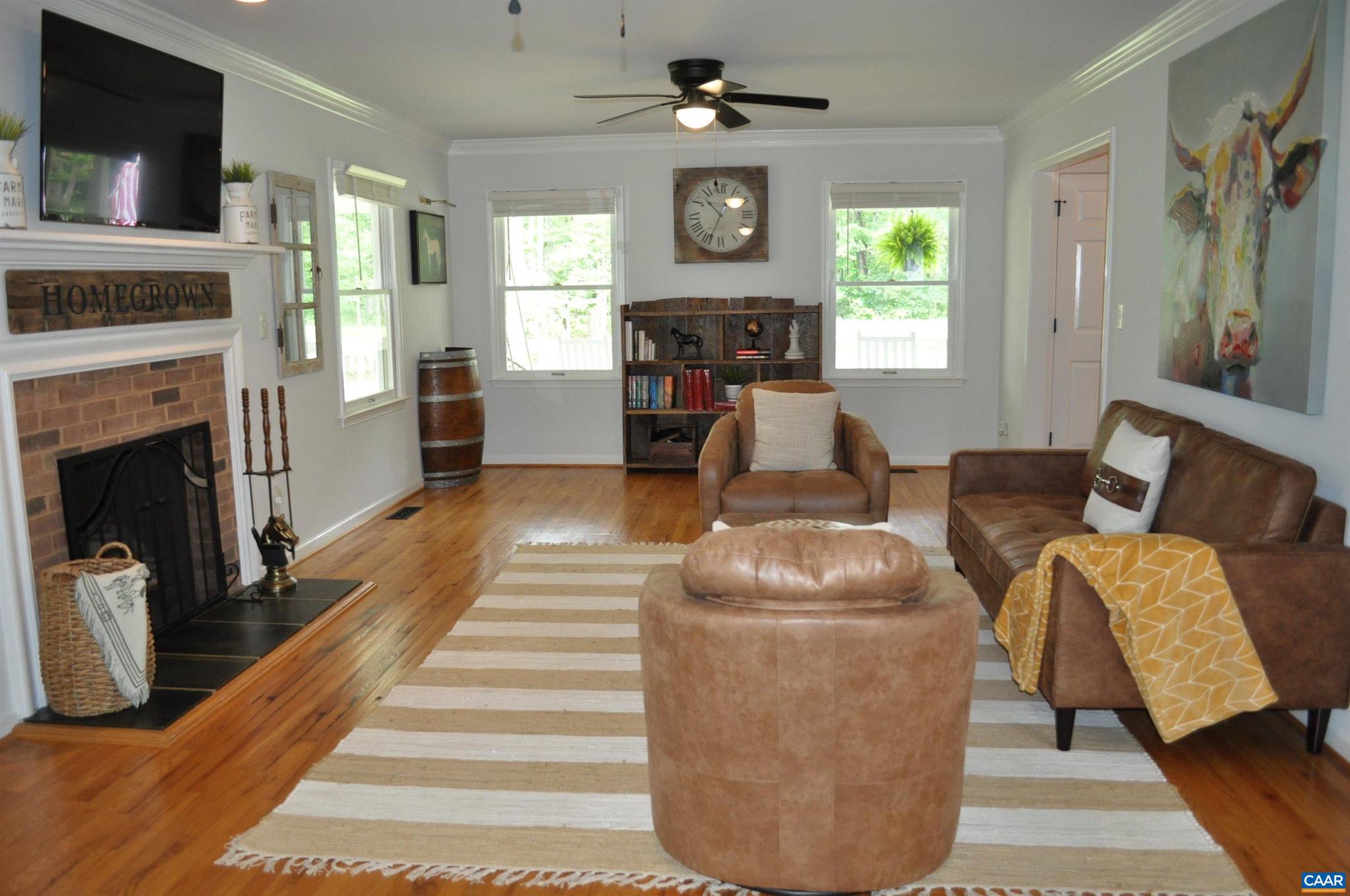 3257 Martin Kings Road Charlottesville, VA 22902 - Photo 8 of 49 a living room with furniture a fireplace and a flat screen tv