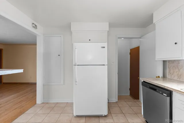 a kitchen with white cabinets and white appliances
