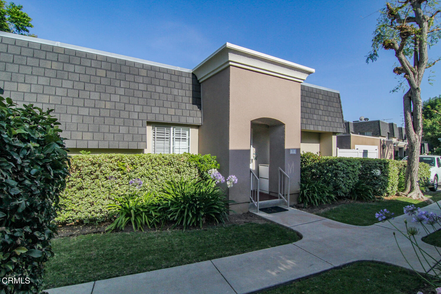 19230 Hamlin Street, Unit 1 Reseda, CA 91335 - Photo 1 of 17 a front view of a house with a yard