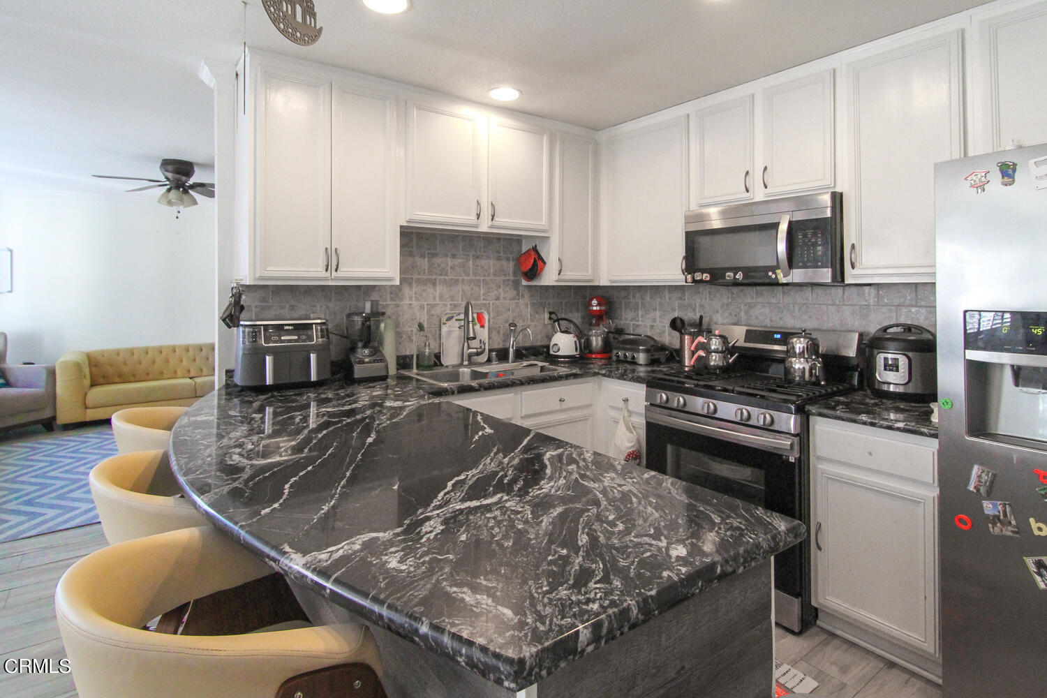 19230 Hamlin Street, Unit 1 Reseda, CA 91335 - Photo 6 of 17 a kitchen with stainless steel appliances granite countertop a sink a stove and a refrigerator