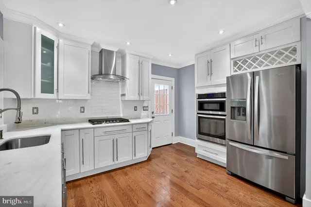 a kitchen with a refrigerator sink and cabinets