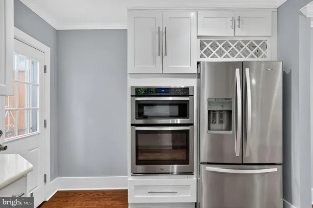 a kitchen with a refrigerator stainless steel appliances and cabinets