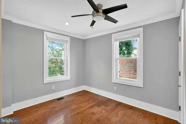 an empty room with windows and closet