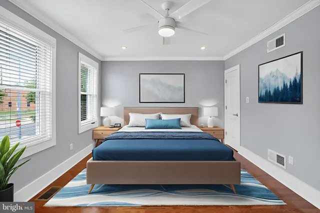 a bedroom with a large bed and a painting on the wall