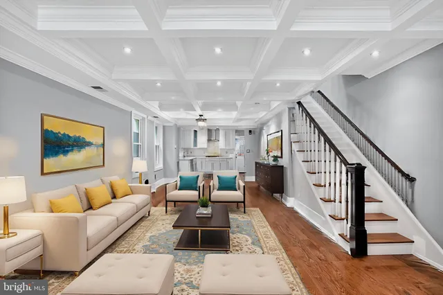 a living room with furniture and a ceiling fan