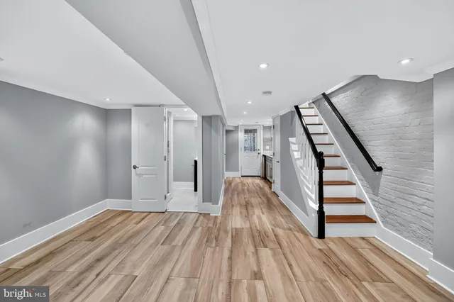 a view of a room with wooden floor and staircase