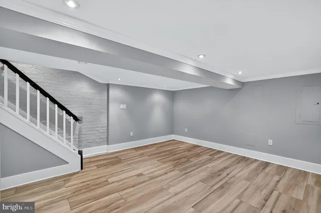 a view of an empty room with wooden floor