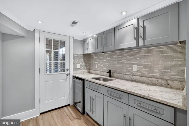 a kitchen with a sink and cabinets