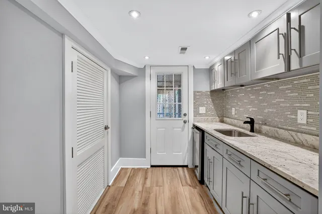 a kitchen with a sink and cabinets