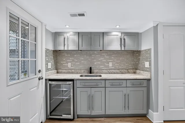 a kitchen with stainless steel appliances granite countertop a sink and a stove