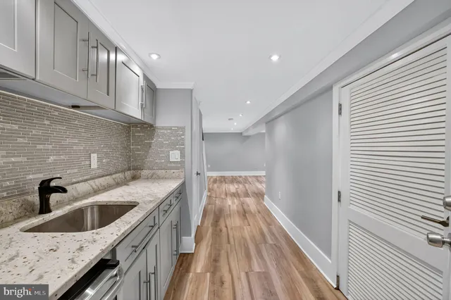 a kitchen with a sink and cabinets