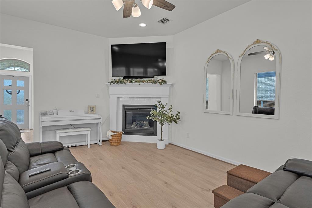 228 Palo Duro Bend Rhome, TX 76078 - Photo 24 of 35 a living room with furniture a flat screen tv and a fireplace