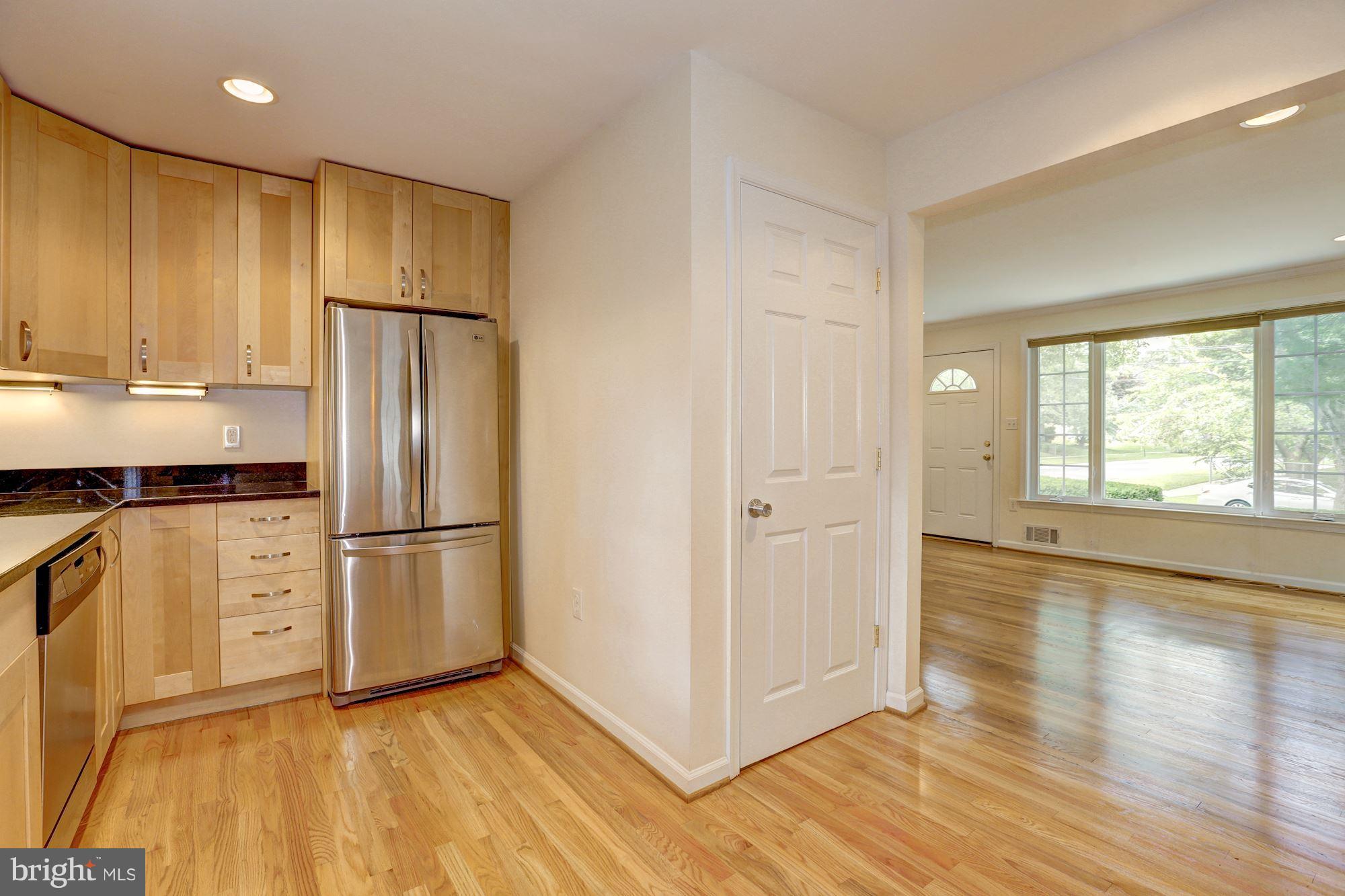 10409 Procter Street Silver Spring, MD 20901 - Photo 11 of 30 a view of a kitchen with a stove wooden cabinets and wooden floor
