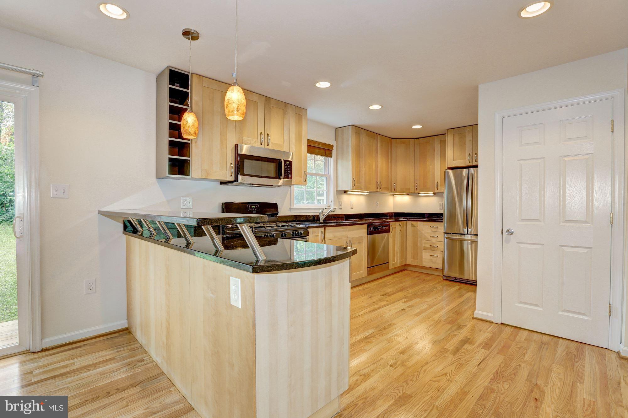 10409 Procter Street Silver Spring, MD 20901 - Photo 13 of 30 a kitchen with kitchen island a sink stainless steel appliances and cabinets