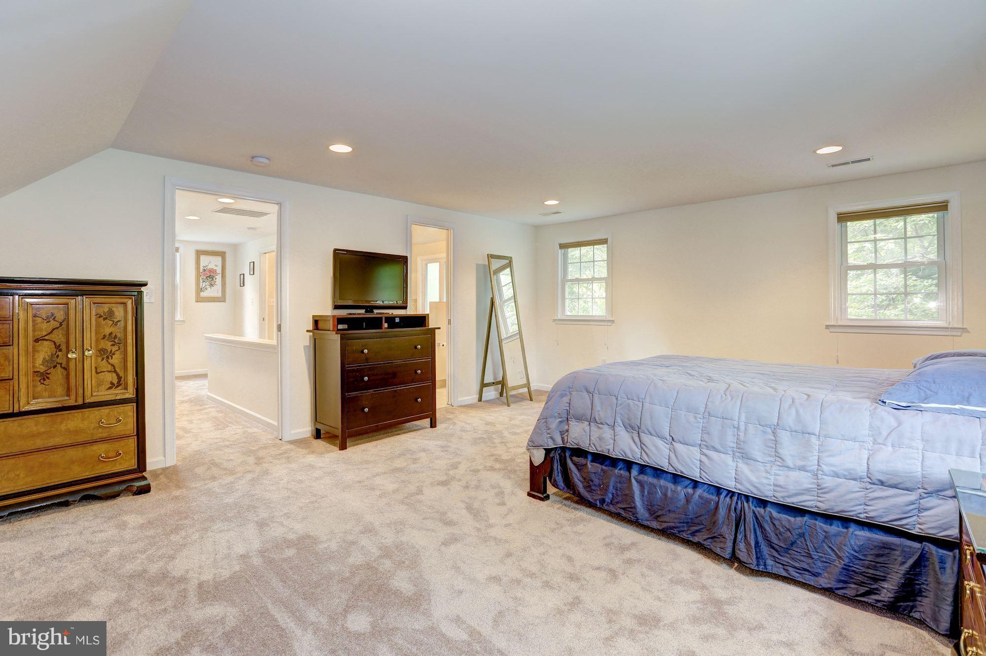 10409 Procter Street Silver Spring, MD 20901 - Photo 19 of 30 a spacious bedroom with a bed and a television in it