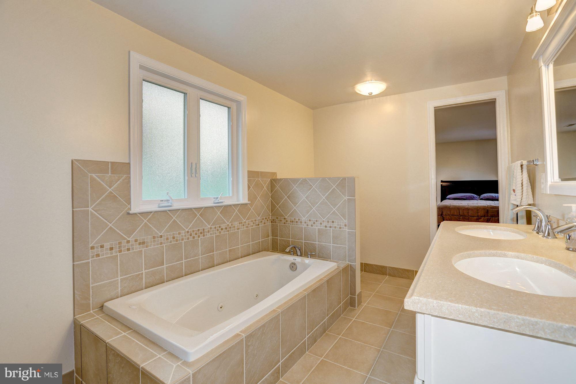 10409 Procter Street Silver Spring, MD 20901 - Photo 21 of 30 a bathroom with a tub sink and mirror