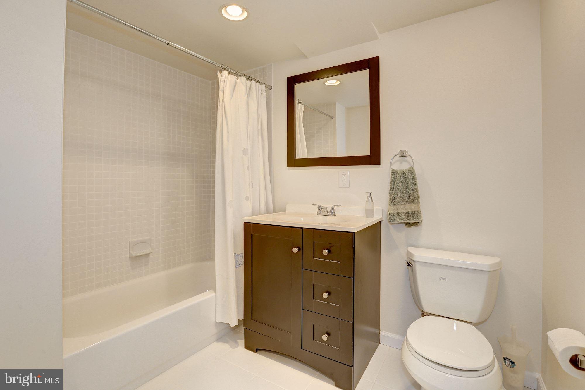 10409 Procter Street Silver Spring, MD 20901 - Photo 25 of 30 a bathroom with a toilet a sink and bathtub