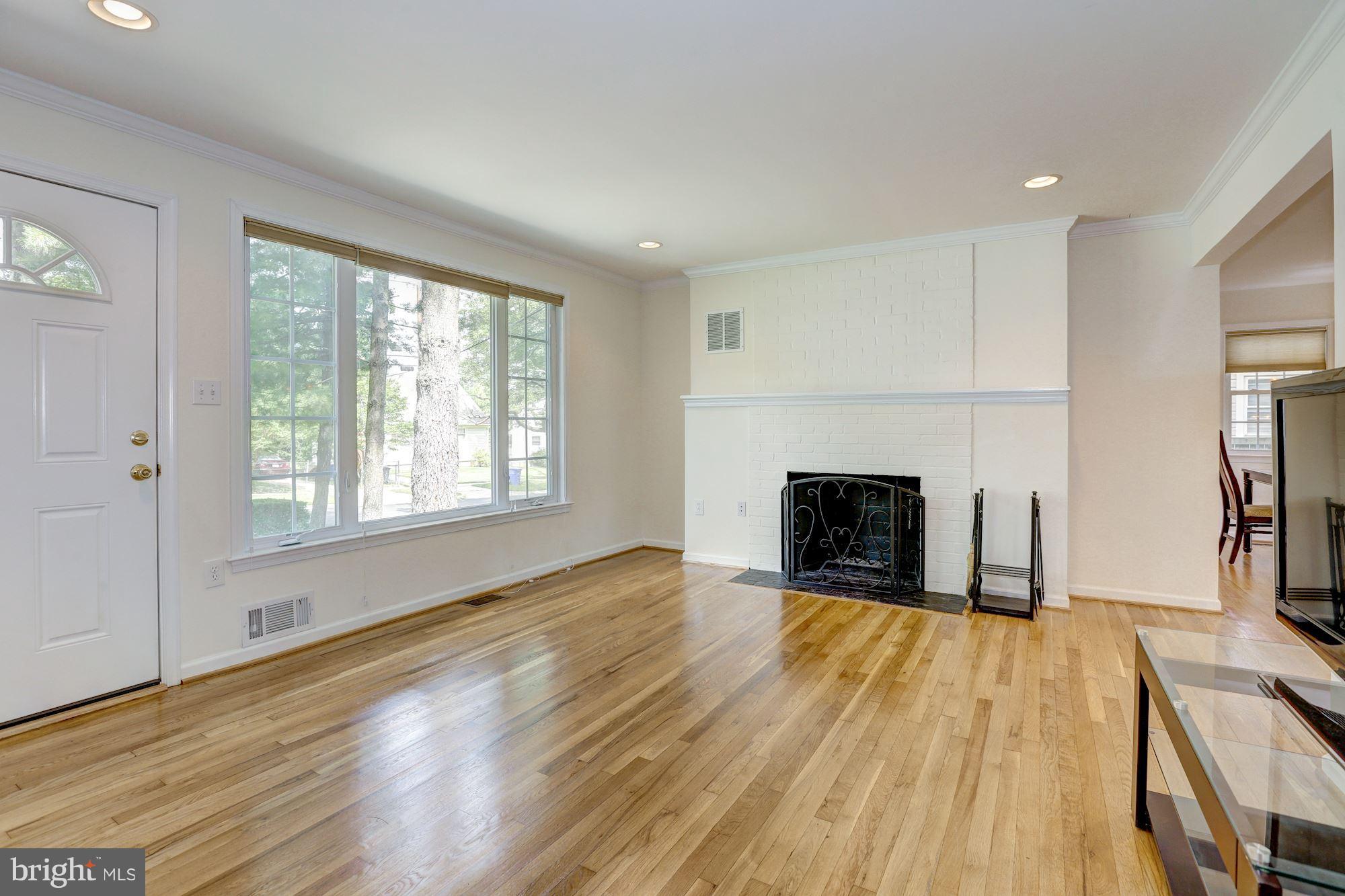 10409 Procter Street Silver Spring, MD 20901 - Photo 4 of 30 an empty room with windows and a fireplace
