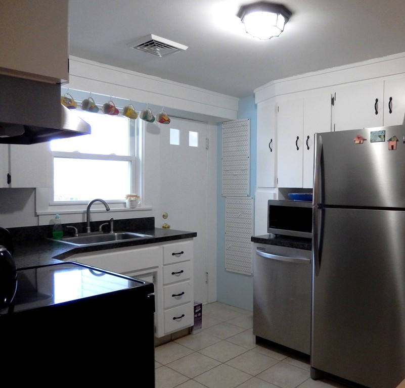 6 James Road Sharon, MA 02067 - Photo 4 of 10 a kitchen with a sink appliances and cabinets