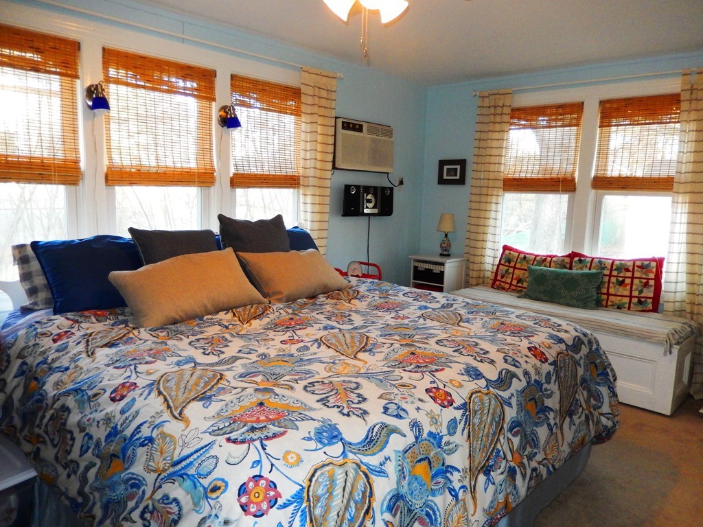 6 James Road Sharon, MA 02067 - Photo 6 of 10 a bedroom with a bed and a couch next to a window