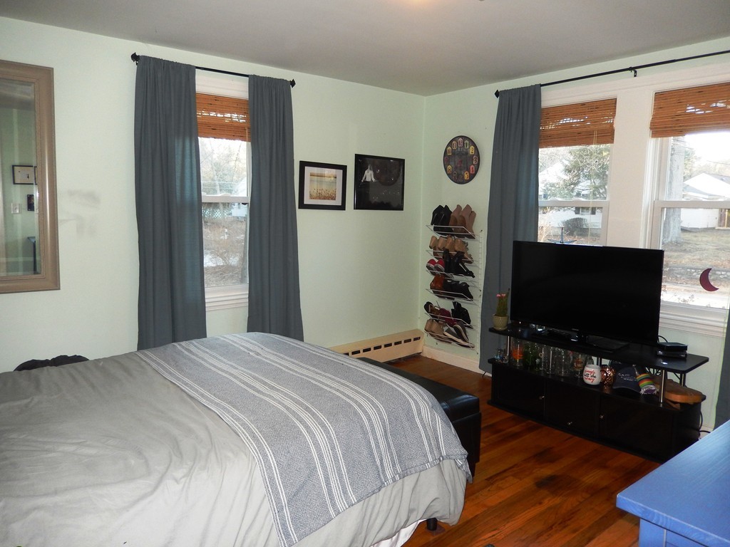 6 James Road Sharon, MA 02067 - Photo 8 of 10 a bedroom with a bed and a flat screen tv